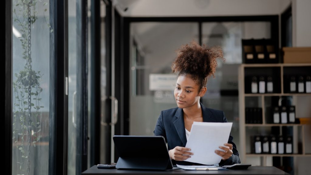 American woman sits in the office of a startup company.