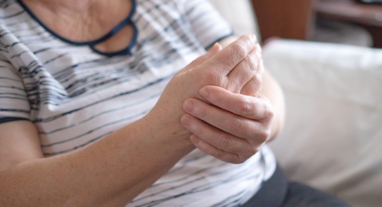 hands of an elderly woman, the problem of the joints of the hands. medicine concept